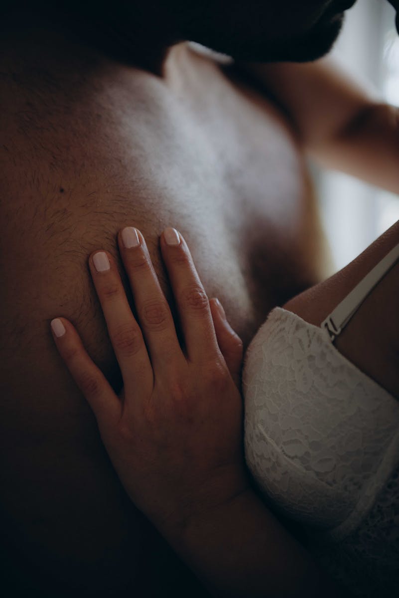 Woman Wearing White Bra Holding Man's Chest